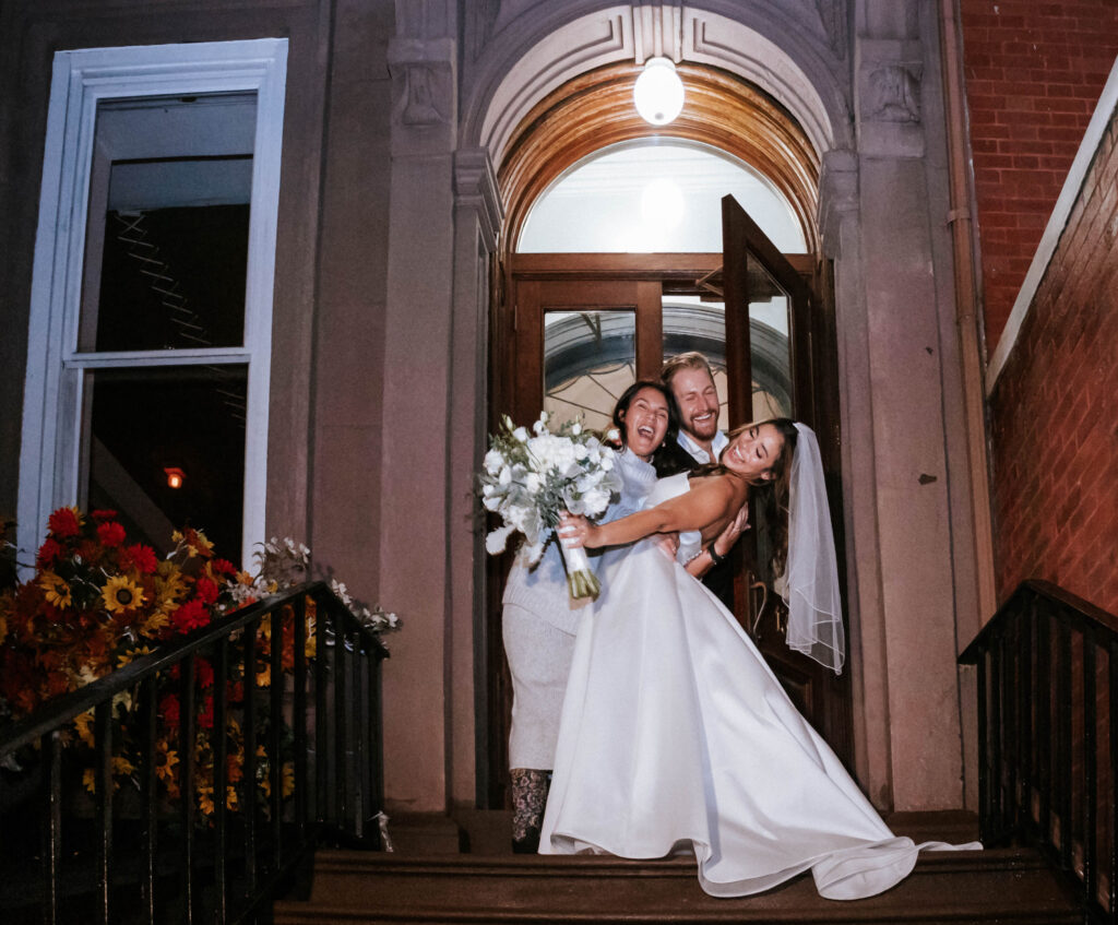 couple-enjoying-bridal-portrait-at-the-east-pole-townhouse-with-firend.