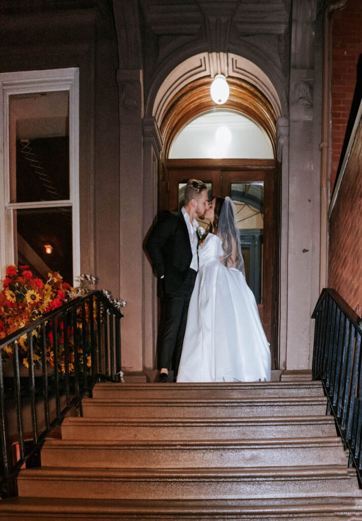 Wedding-couple-enjoying-the-townhouse-entrance-of-the-east-pole-main-floor.