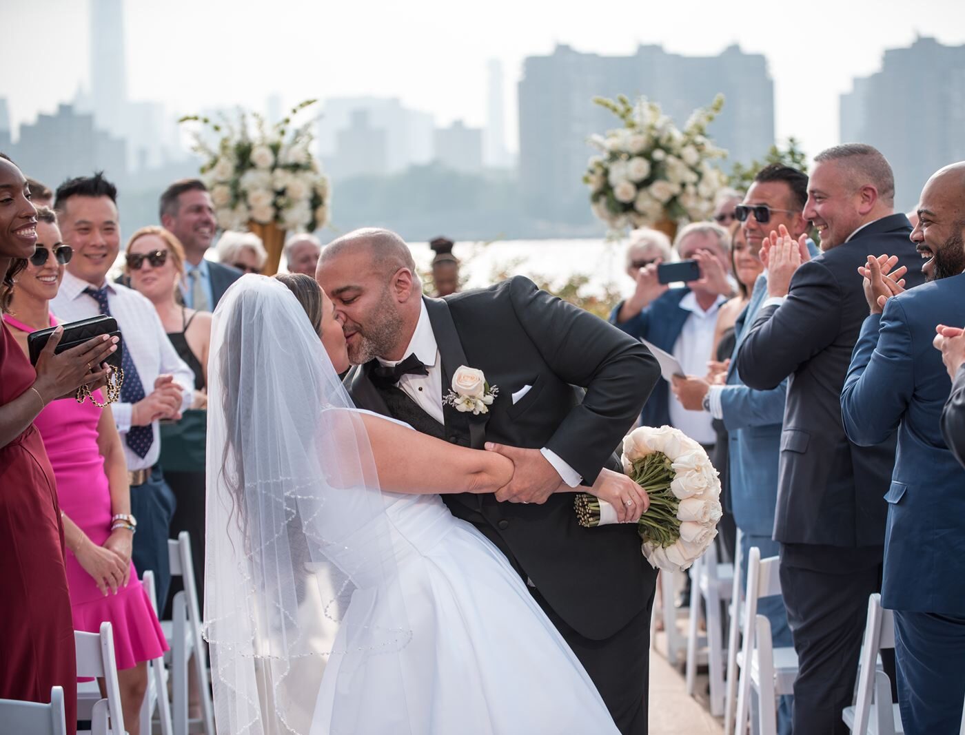 The dip and kiss during the promenade, the city skyline in the background as the guests clap in delight.