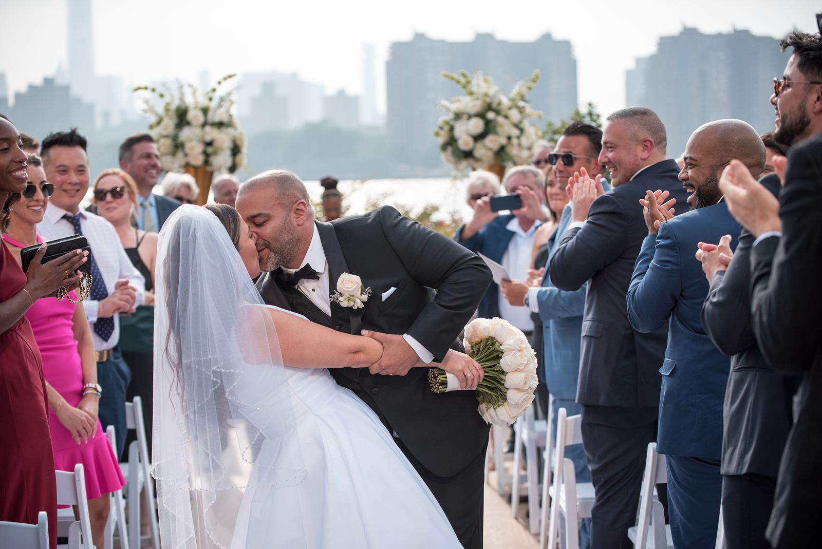 The dip and kiss during the promenade, the city skyline in the background as the guests clap in delight.