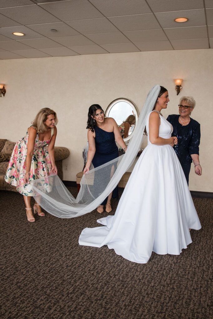 Bride enjoying a getting ready moment with her mother and sisters.