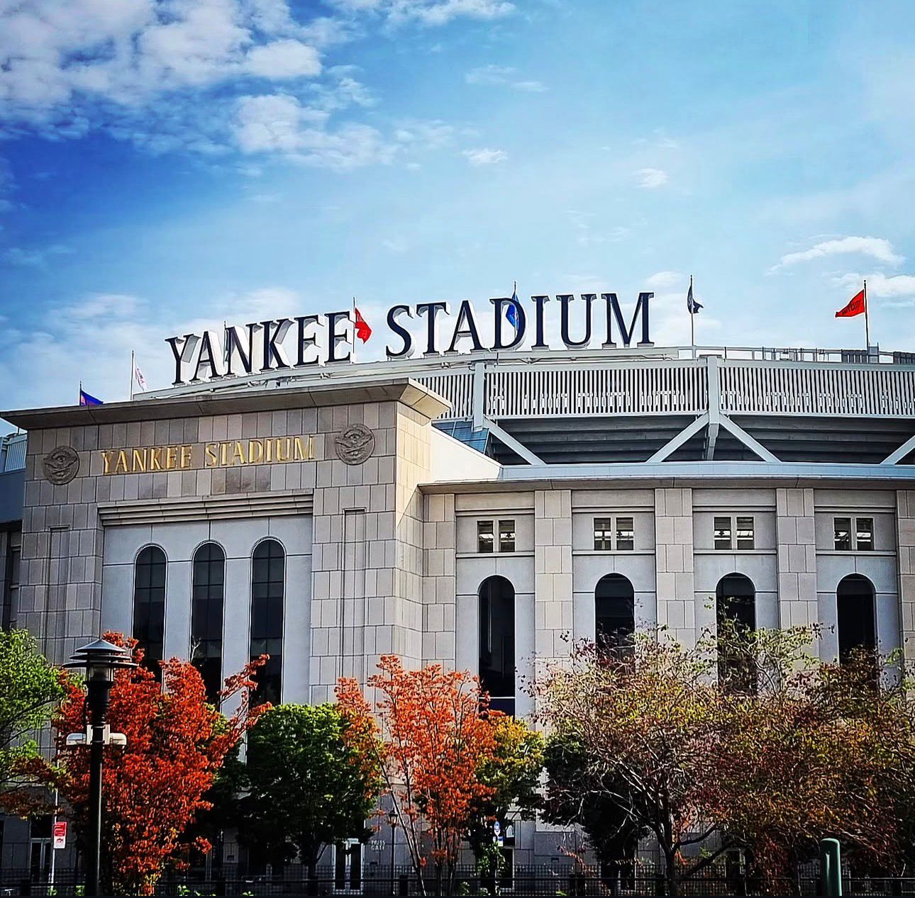 Yankee Stadium facade with iconic lettering and blue sky in New York City.
