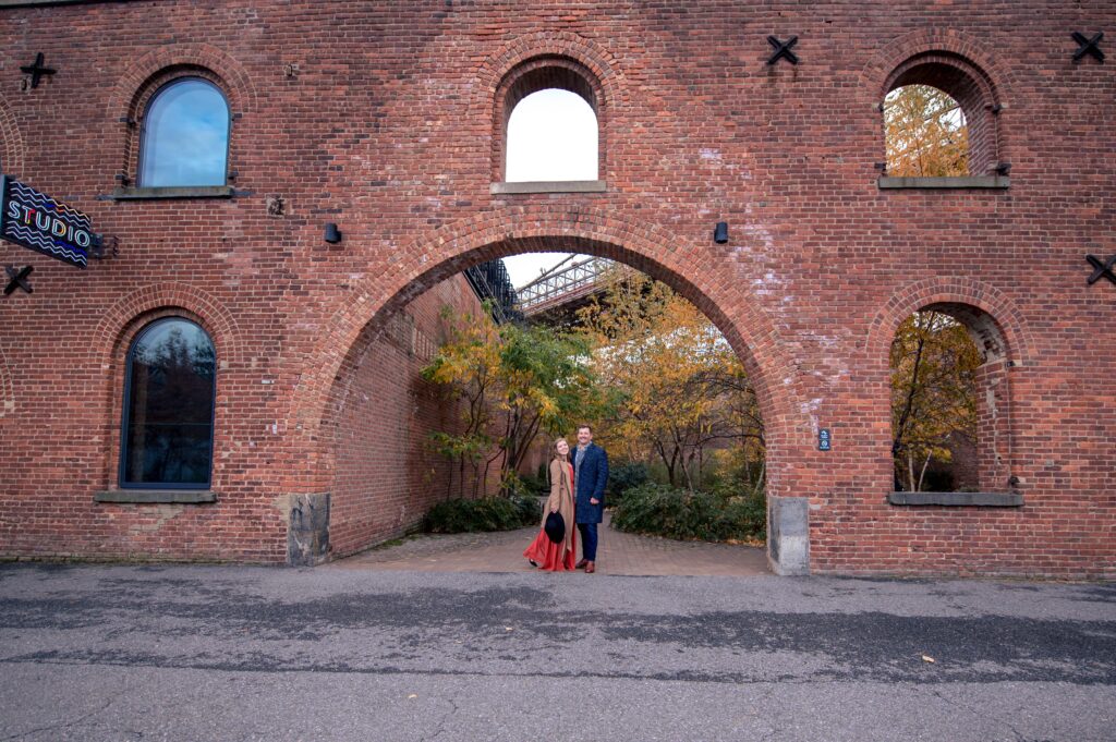 Romantic engagement photo in the Max Family Garden in DUMBO — surrounded by ivy walls and warm autumn tones, captured by NYC engagement and wedding photographer Patricia Parrales, also known as the East River Photographer..