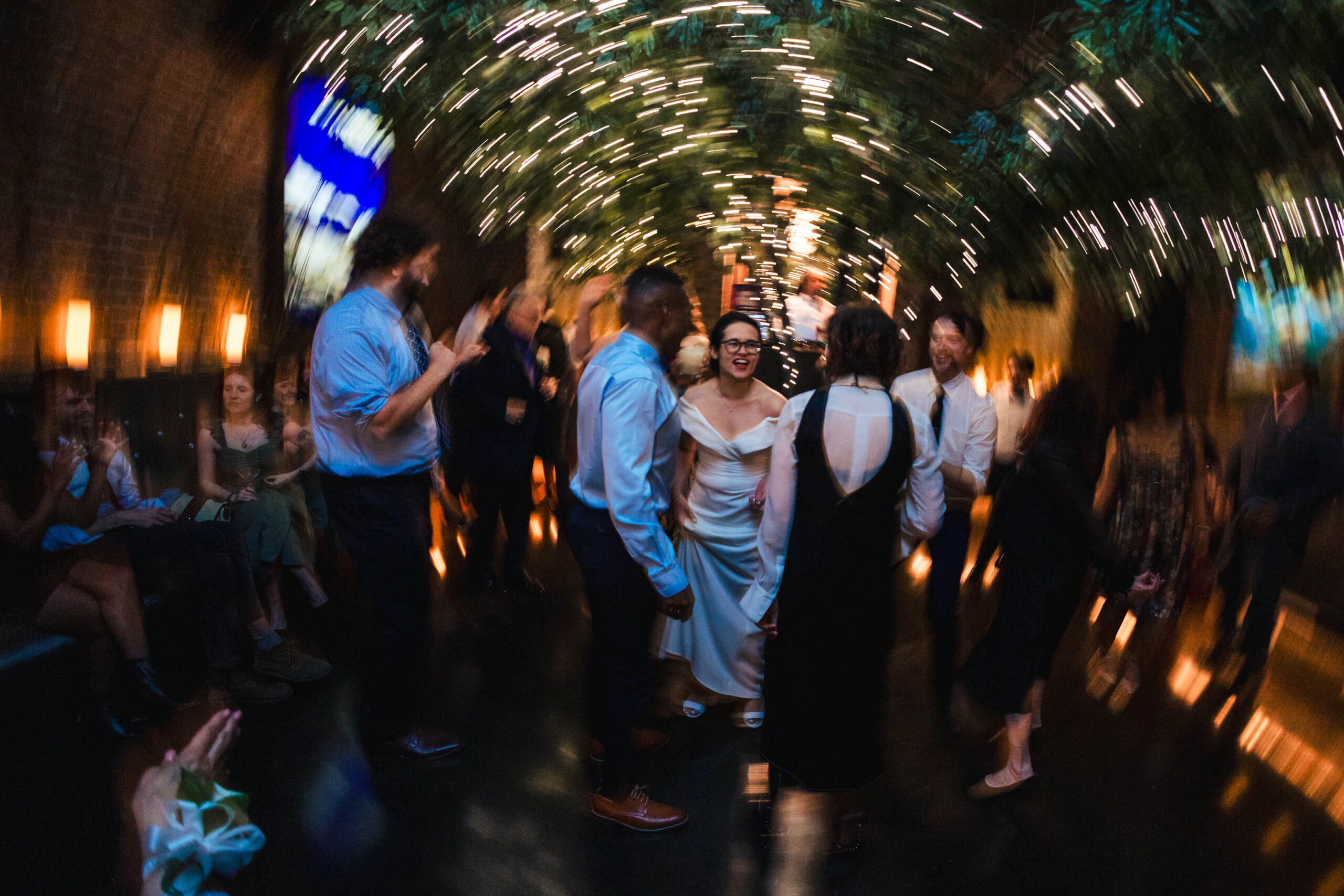 Guest dancing during a micro wedding reception at Deity Brooklyn with motion blur and party atmosphere